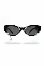 Black cat-eye sunglasses with silver accents on a white background