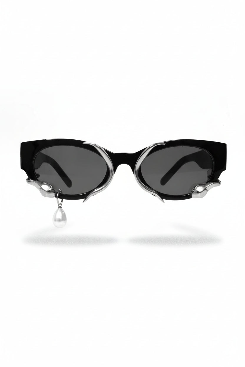 Black cat-eye sunglasses with silver accents on a white background Main image
