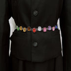 Black coat with a colorful gemstone belt