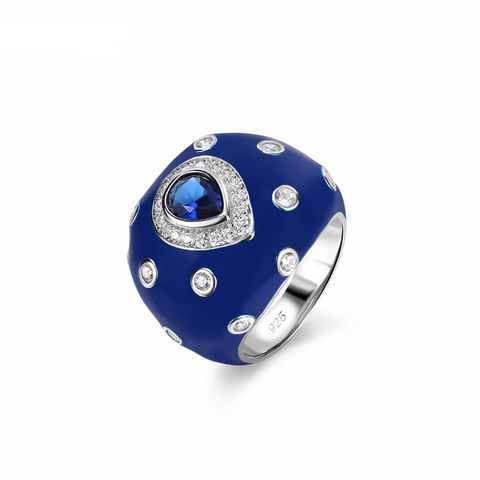 Blue ring with a central gemstone and smaller stones on a white background