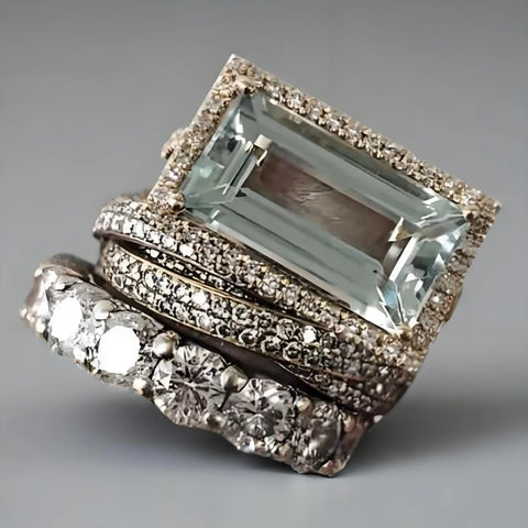 Elegant ring with a large central gemstone and smaller diamonds on a gray background